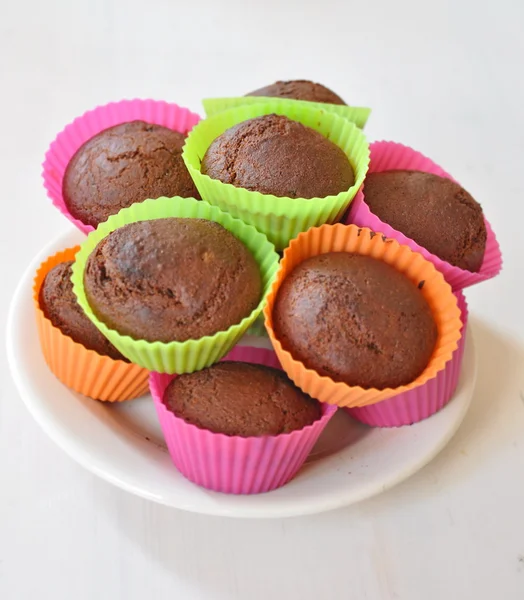 Muffins in colourful plastic cups — Stock Photo, Image