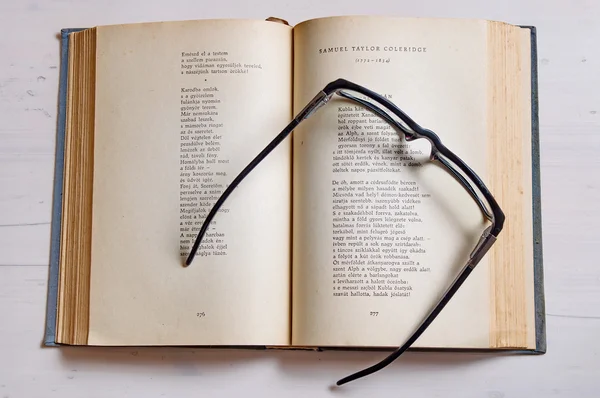 Reading glass on an old book — Stock Photo, Image