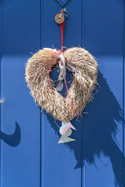 Corazón decorativo de paja sobre azul —  Fotos de Stock