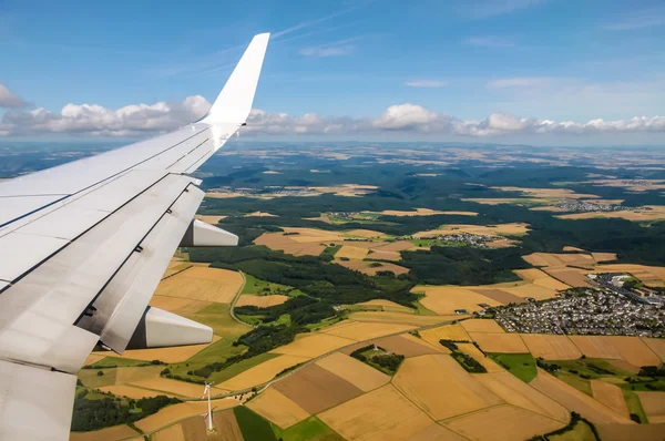 Aerial view of plane wing and fields — Stock Photo, Image