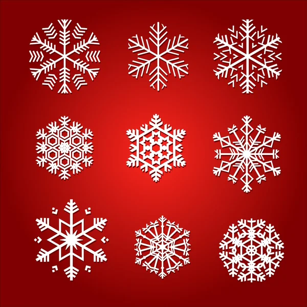 Snowflakes isolated on red background — Stock Vector