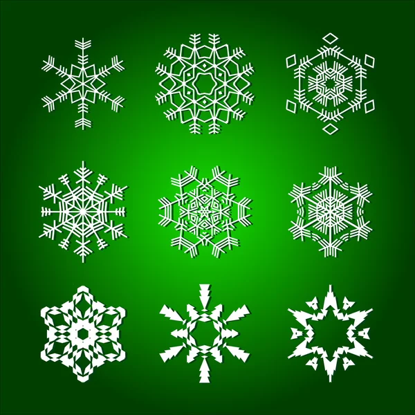 Νιφάδες χιονιού που απομονώνονται σε πράσινο φόντο — Διανυσματικό Αρχείο