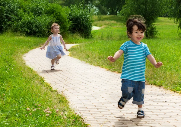 Girl chasing cute boy — Stock Photo, Image