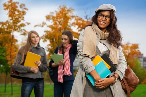 Smiling girl in glasses in park — Stock Photo, Image