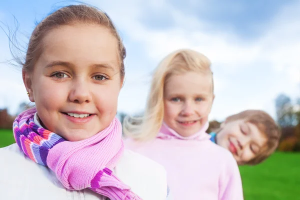 Smiling girl with her friends — Stock Photo, Image