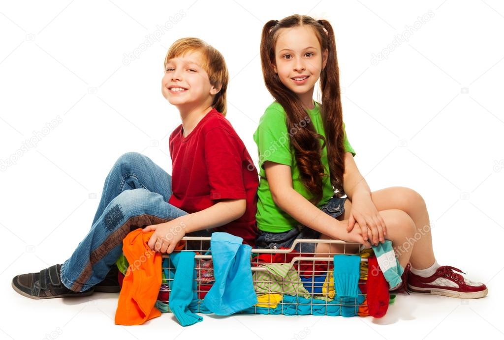 two kids in clothing basket