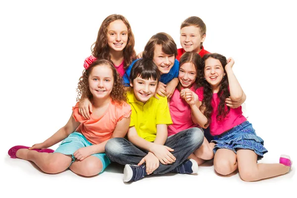 Group of happy kids sitting together — Stock Photo, Image