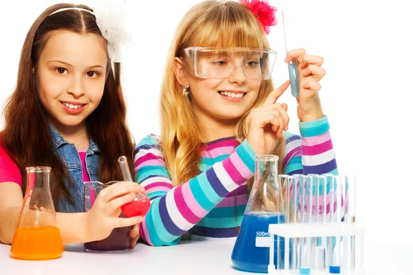Two girls in chemistry class Royalty Free Stock Images