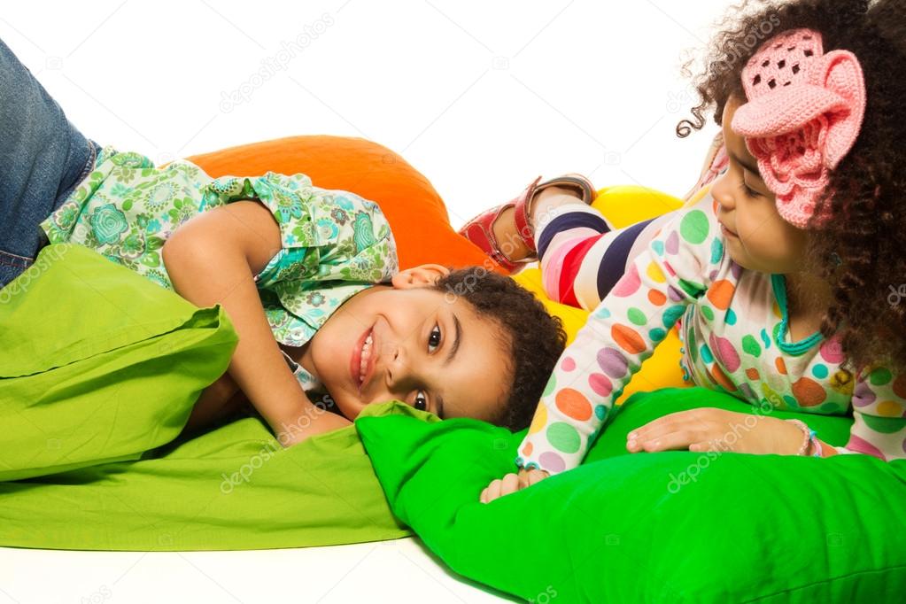 Black boy and girl playing with pillows