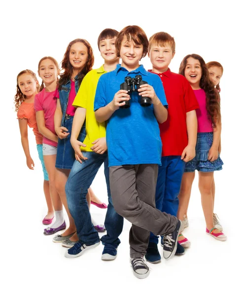 Nice boy with binoculars in a group — Stock Photo, Image