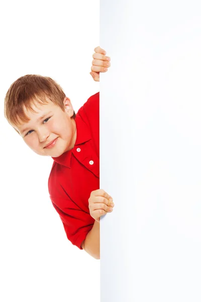 Kid in red shirt with blank billboard Stock Picture