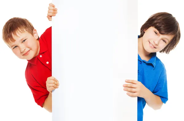 Close-up of boys showing new blank advertising Stock Photo