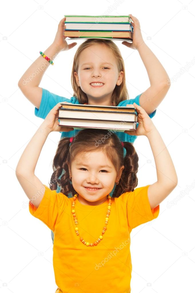 Smart girls with pile of books