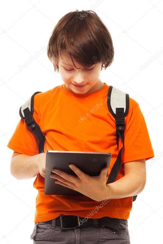 Boy occupied with tablet computer