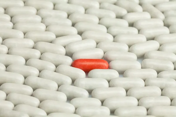 Treasure pill among many white — Stock Photo, Image