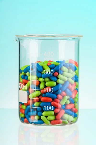 Glass full of color drugs — Stock Photo, Image