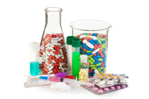 Many different drugs and tablets in laboratory glassware — Stock Photo, Image