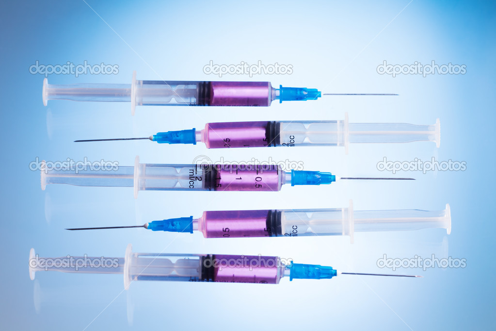 Injections in syringes with pink fluid