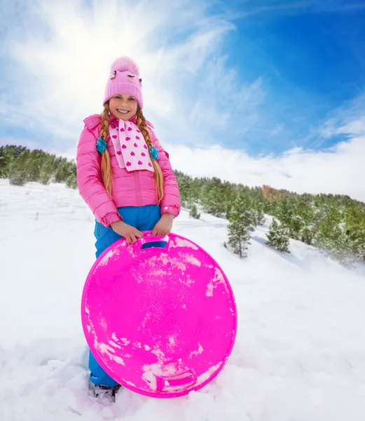 Happy girl in pink holding sled — Stock Photo, Image