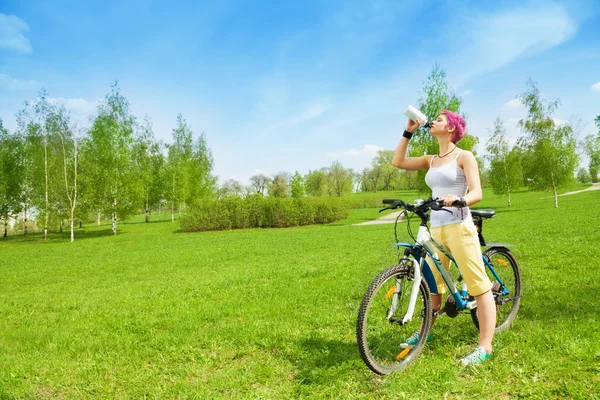 Biker fulfilling thirst — Stock Photo, Image