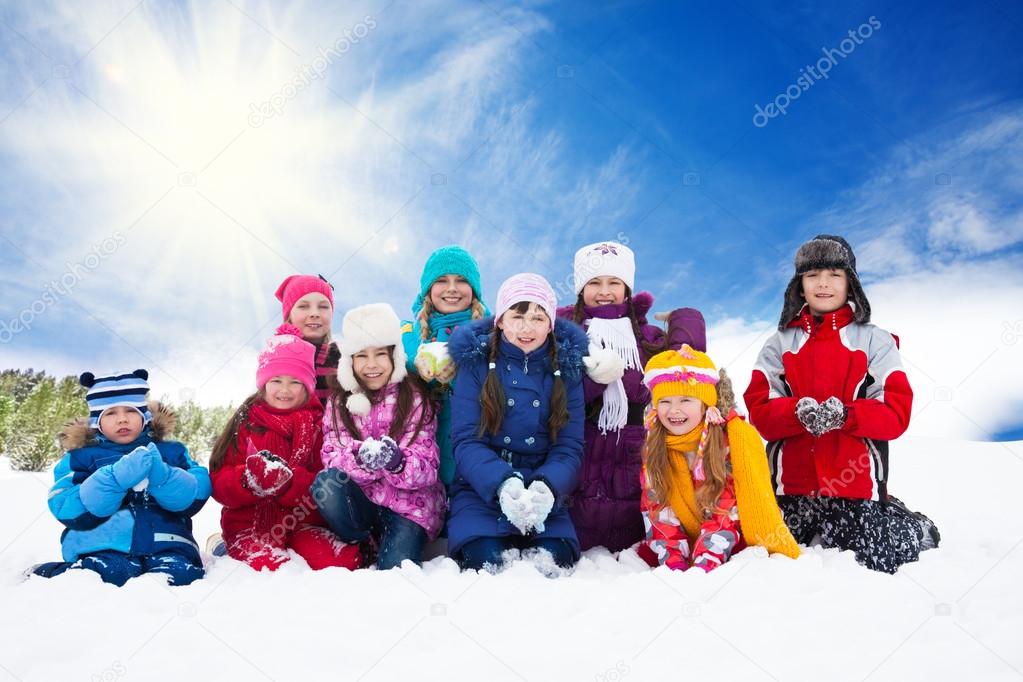 Large group of happy kids throwing snow