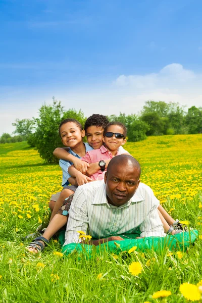 Kids sit on fathers back — Stock Photo, Image