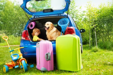 Kid, dog and luggage waiting for depature clipart