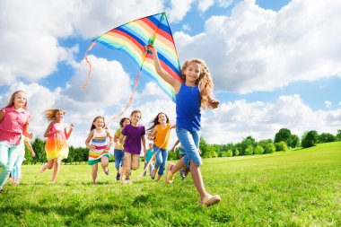 Cool girl with kite and her friends clipart