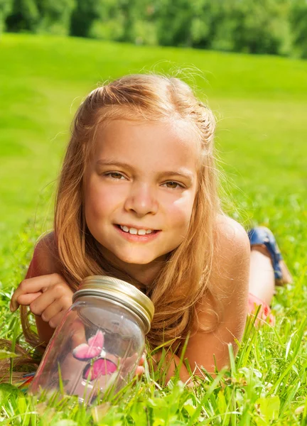 One blond girls with butterfly in jar — Stock Photo, Image