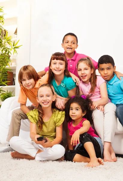 Group of kids with TV remote controll — Stock Photo, Image