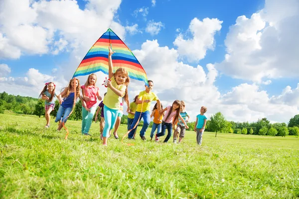 Little girl with friends and kite — Stock Photo, Image