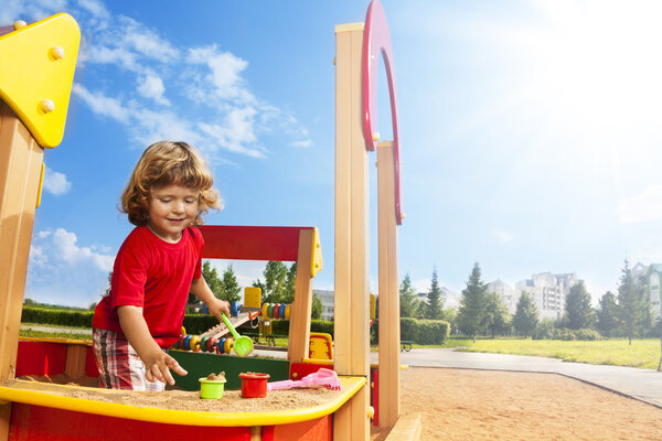 Little boy playing in sandbox