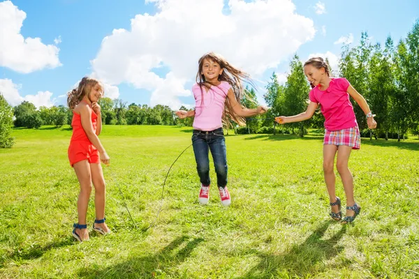 Girls play jumping over the rope — Stock Photo, Image