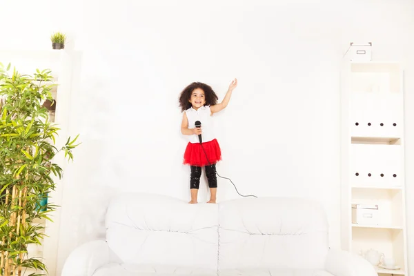 Cute little black African three years old girl with microphone — Stock Photo, Image