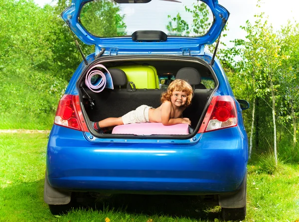 Boy in the trunk with baggage — Stock Photo, Image