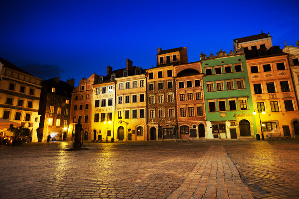 Warsaw old town marketplace square at night with colorful houses and stone pavement in Poland