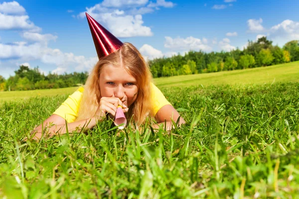 Blowing in party noisemaker whistle — Stock Photo, Image