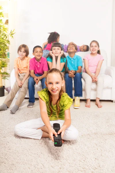 Little girl with TV remote control — Stock Photo, Image