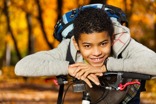 Boy smile laying on bike stern — Stock Photo, Image