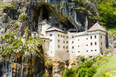 Predjama castle inside the mountain clipart