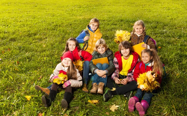 Дети сидят на лужайке — стоковое фото