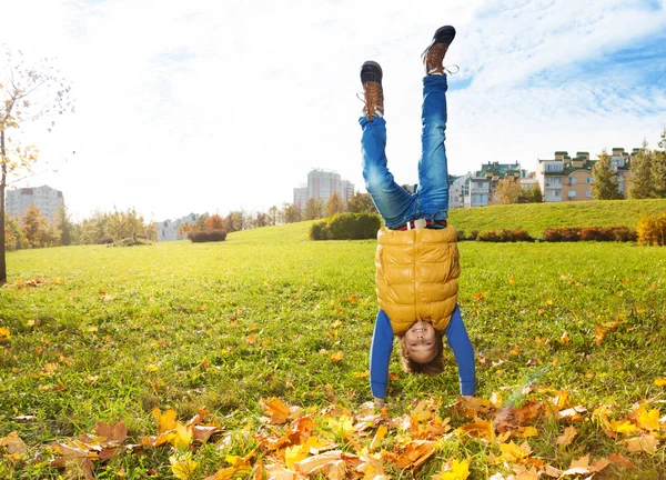 Boy stands on hands — Stock Photo, Image