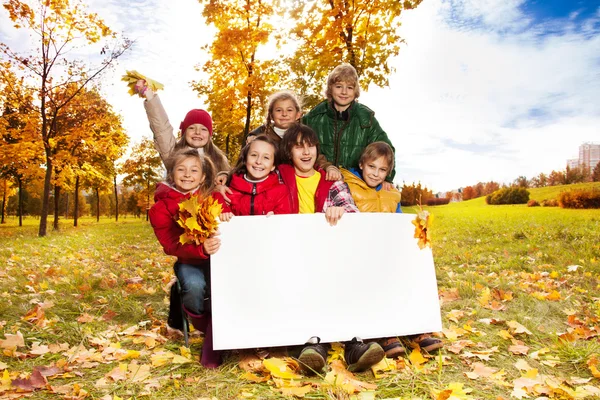 Happy kids with blank placard — Stock Photo, Image
