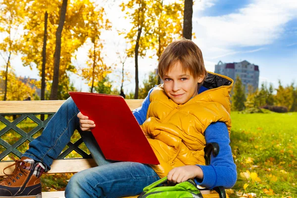 Boy after school in the park — Stock Photo, Image