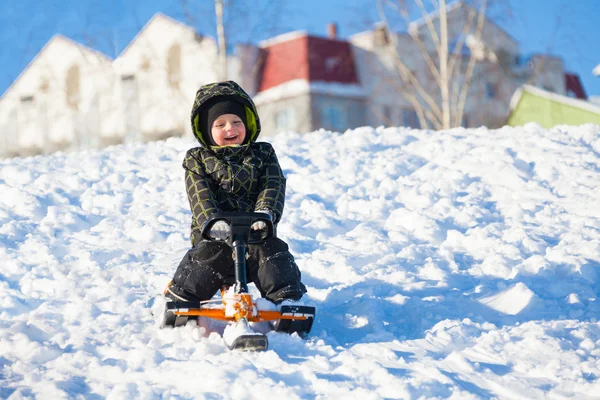 Little boy sledding — Stock Photo, Image