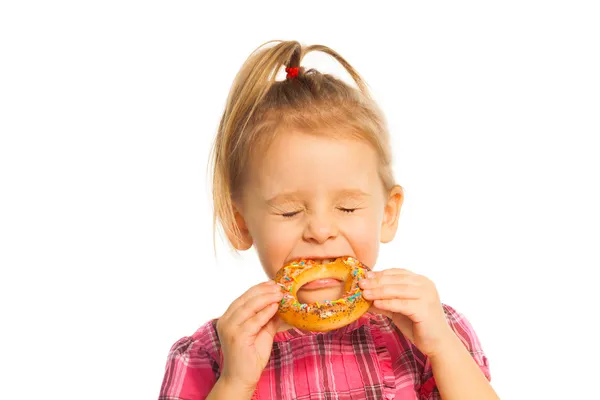 Little girl biting bread ring — Stock Photo, Image