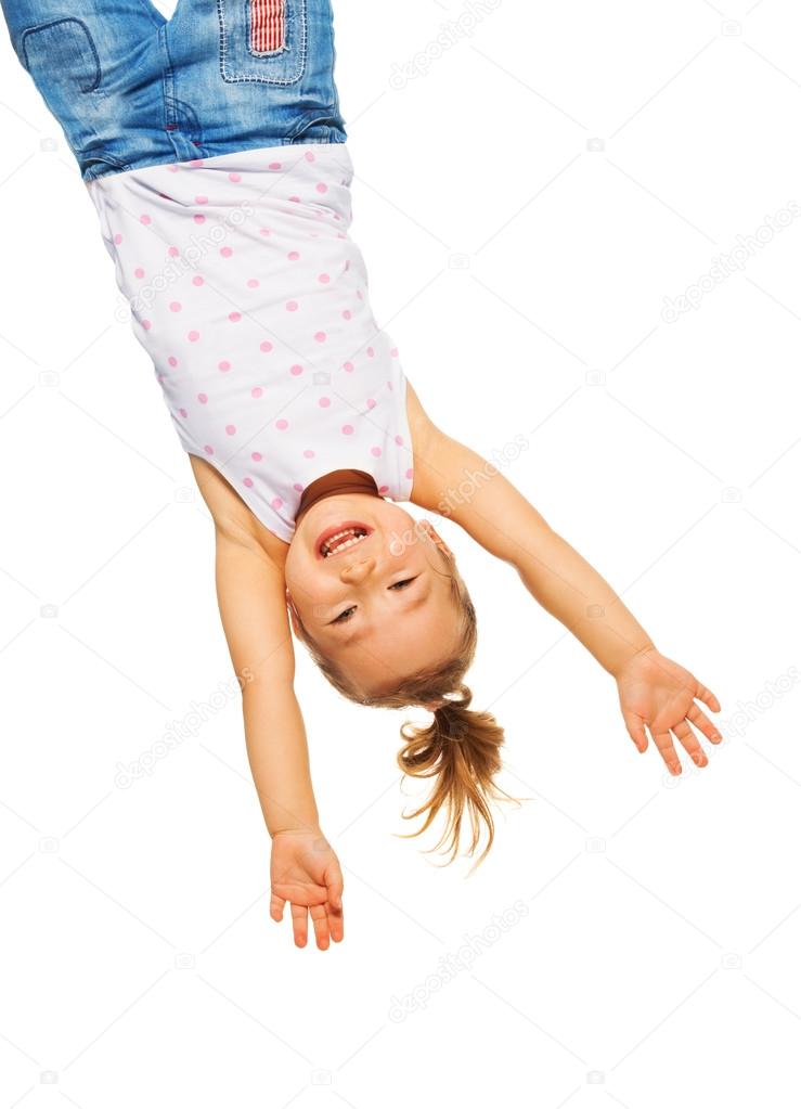 Little girl hanging upside down