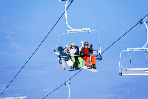 Three   snowboarders on ropeway — Stock Photo, Image
