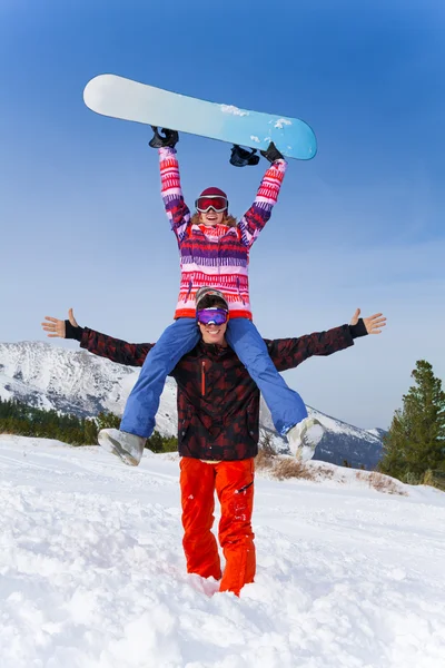 Snowboarder with girl on his shoulders — Stock Photo, Image