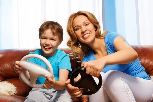 Child and mom driving steering wheels — Stock Photo, Image